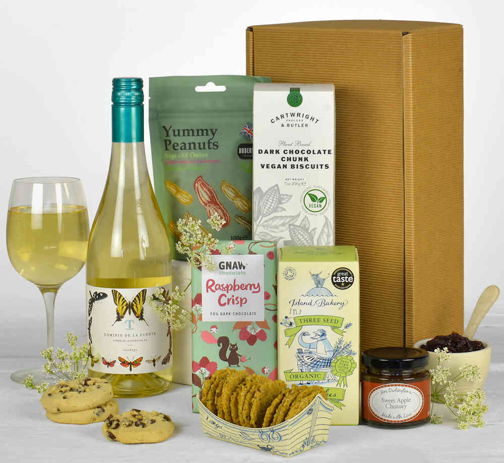 a bottle of white wine and vegan treats in a natural gift box