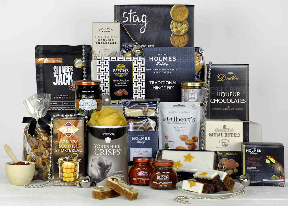 Luxury Christmas food including savoury biscuits, english tea, traditional mince pies, iced Christmas cake, Christmas pudding and Liqueur Chocolates
