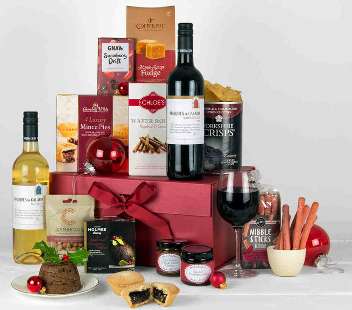Luxury Christmas Hamper with Red and White wine, mince pies, Christmas pudding, savoury snacks, fudge and a chocolate bar in a Luxury Red Gift Box with Red Ribbon