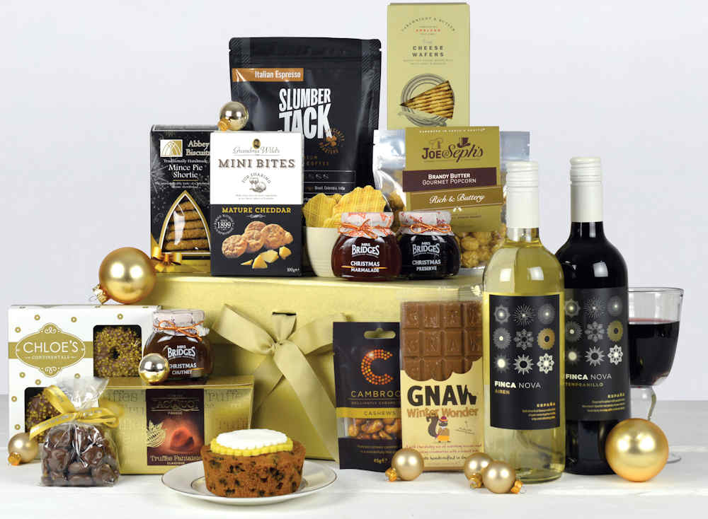 Luxury christmas hamper in a gold box with two bottles of wine, christmas cake, biscuits, chocolate, nuts, preserve and other popular snacks