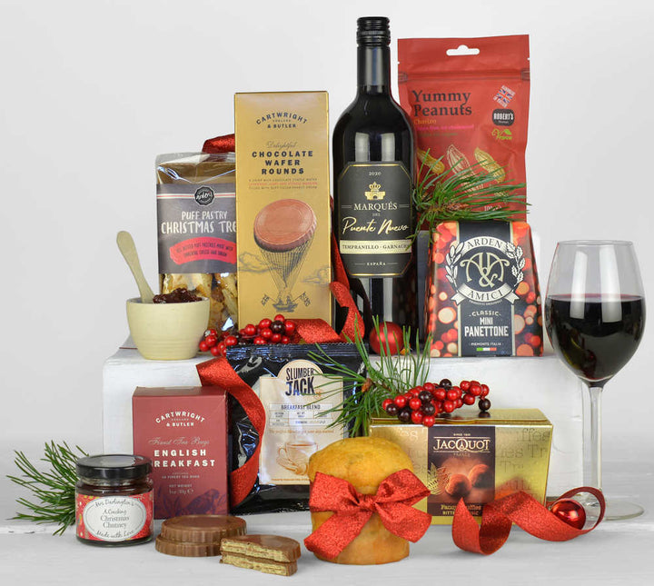 Christmas hamper with red wine, chocolate biscuits, Italian panettone, tea, coffee, chutney, Christmas savoury snacks, nuts and chocolates