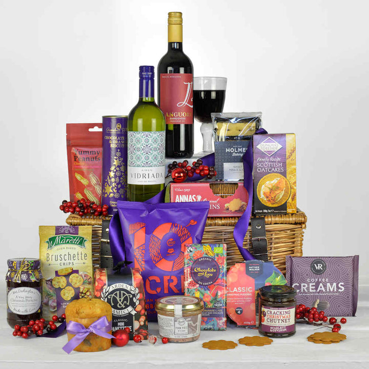 Wicker Basket with Red and White wine, Christmas pudding, italian penttone, oatcakes, pate, chutney and other tast treats