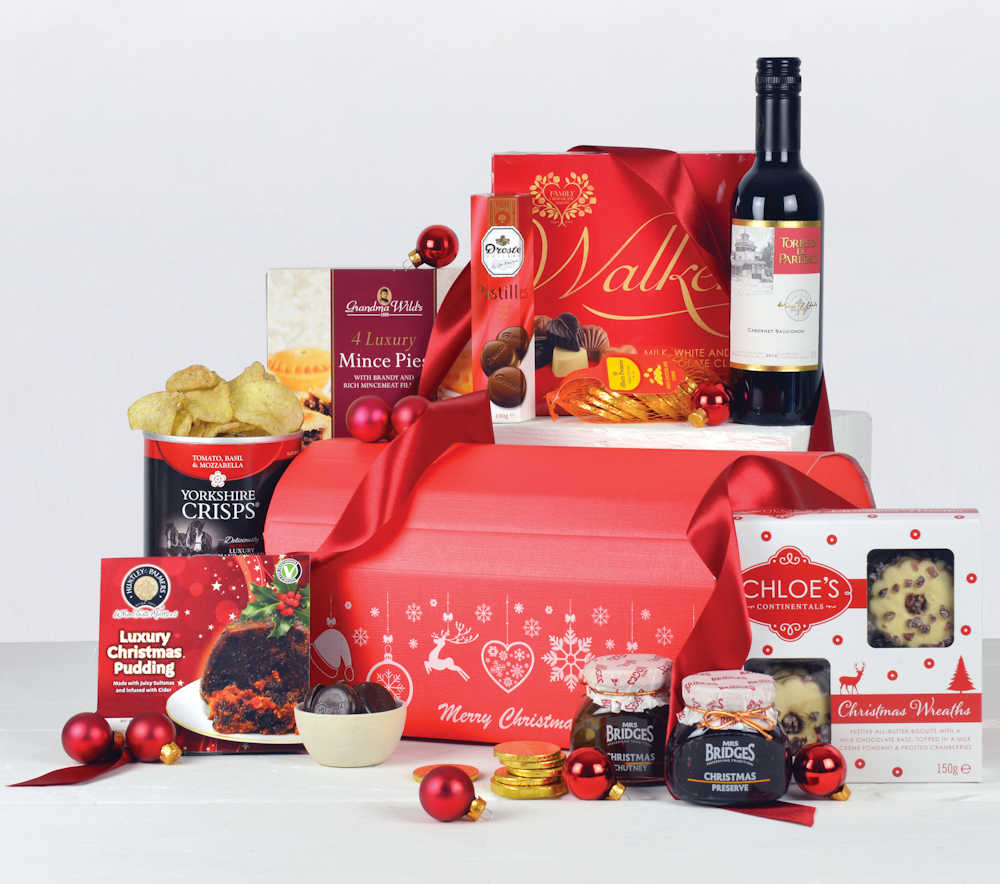 Merry Christmas Red Gift Box with red wine, chocolates, Christmas pudding, minces pies and other festive treats