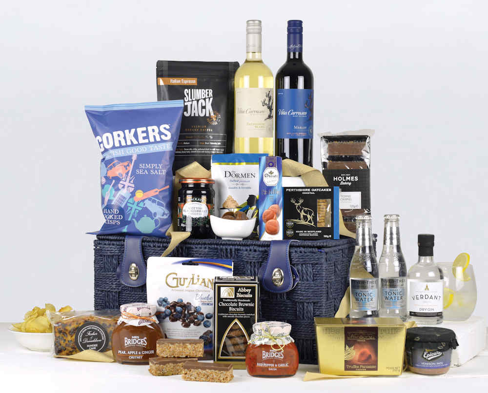 a blue twisted rope basket filled with 2 bottles of wine gin and tonics and a well balanced range of high quality products