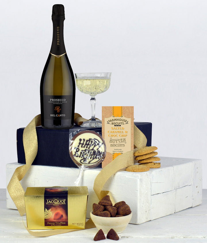 A bottle of prosecco, biscuits, french truffle chocolates and a Happy birthday Chocolate Lolly in a black gift box