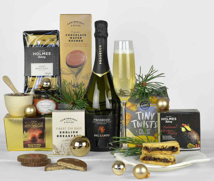 Bottle of Prosecco, christmas pudding, tea, chocolate biscuits, cheesy snacks, sweet mince pie slices and a french chocolate truffles