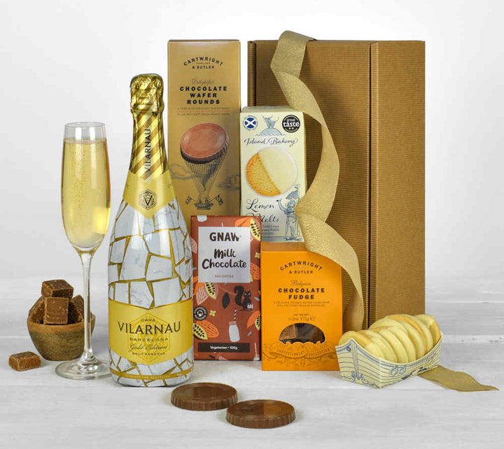limited edition sparkling wine with chocolate biscuits, fudge and other sweet treats in a natural gift box, all made from sustainable companies