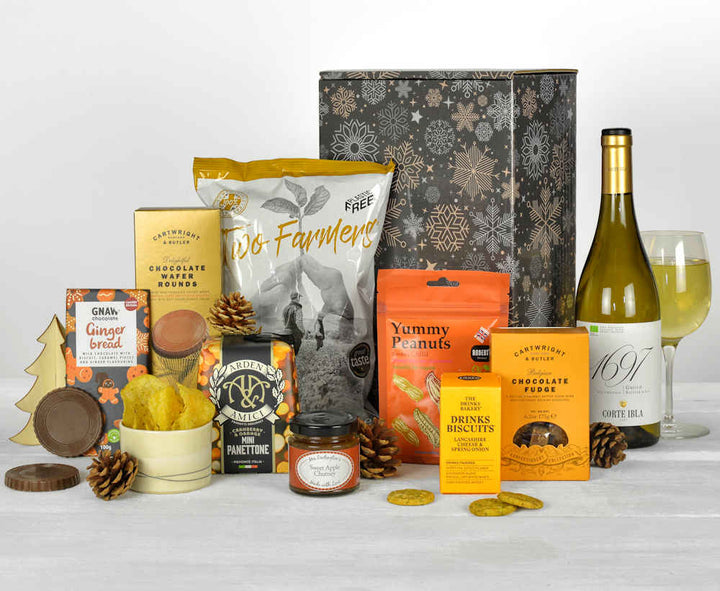 a bottle of wine and christmas themed products including a panettone and gingerbread chocolate in  a sustainable gift box
