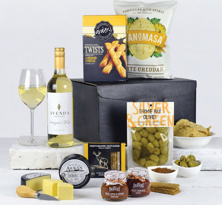white wine with savoury snacks, olives, chutney, salsa and cheese in a black gift box