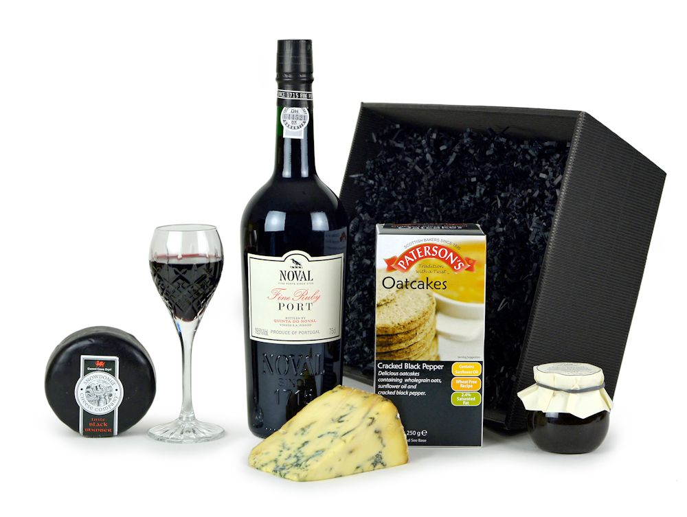 A bottle of Fine Ruby Port, oatcakes, a chutney and cheese in a black gift tray